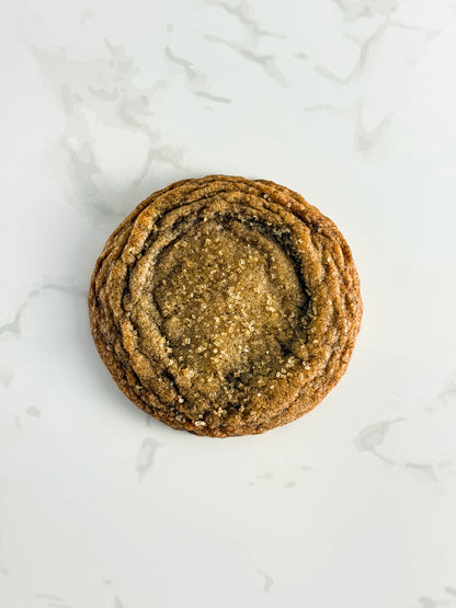 Half Three Earl Grey and orange cookie with a demerara sugar press and golden, wrinkled edges