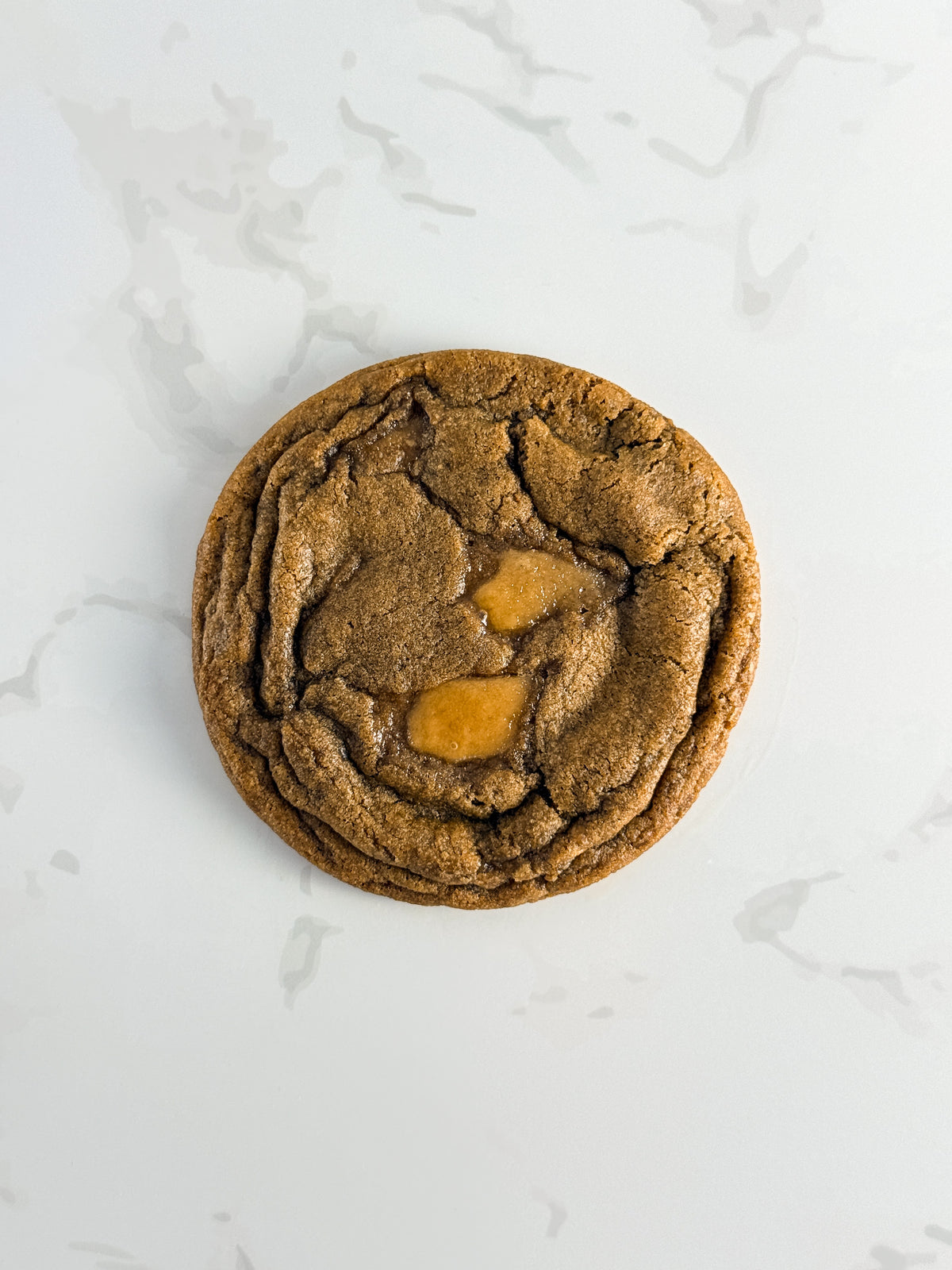 Half Three espresso toffee cookie with visible toffee pieces and a thin chewy texture
