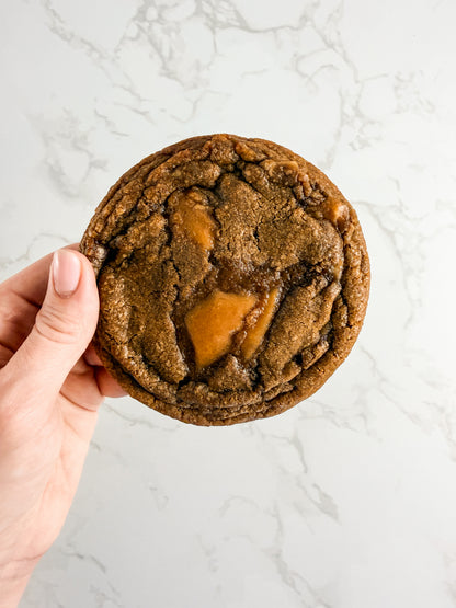 Hand holding a Half Three espresso toffee cookie