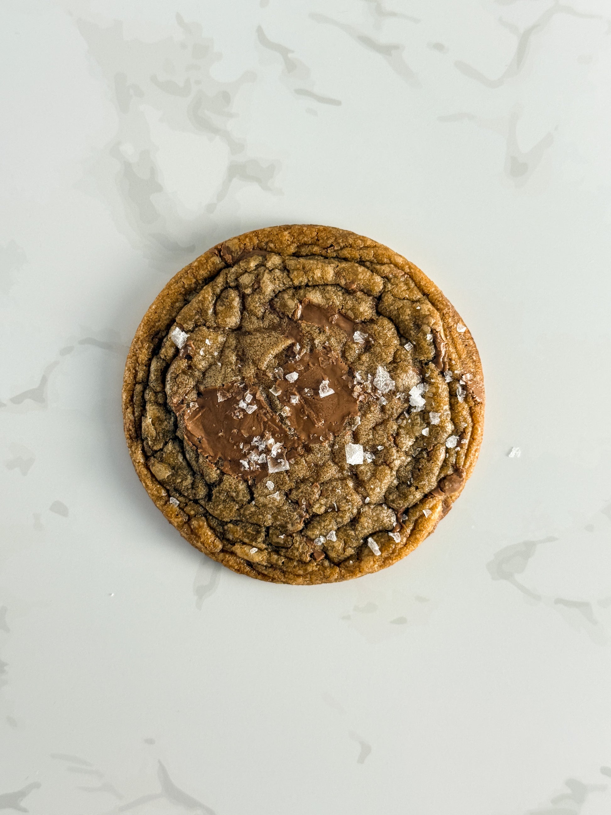 Half Three milk chocolate and sea salt cookie with melted milk chocolate pools and Maldon salt flakes