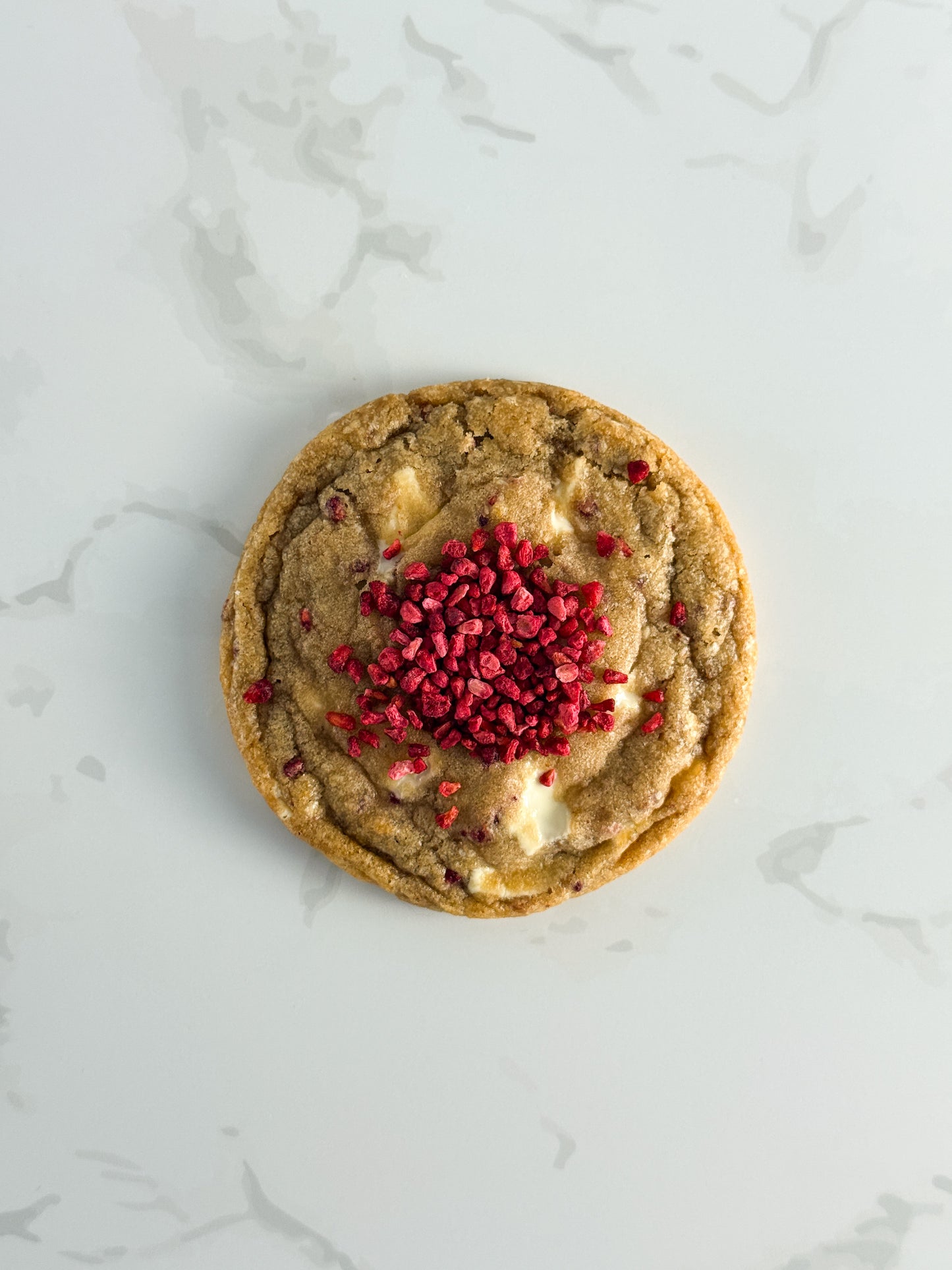 Half Three white chocolate and raspberry cookie topped with freeze-dried raspberries and white chocolate
