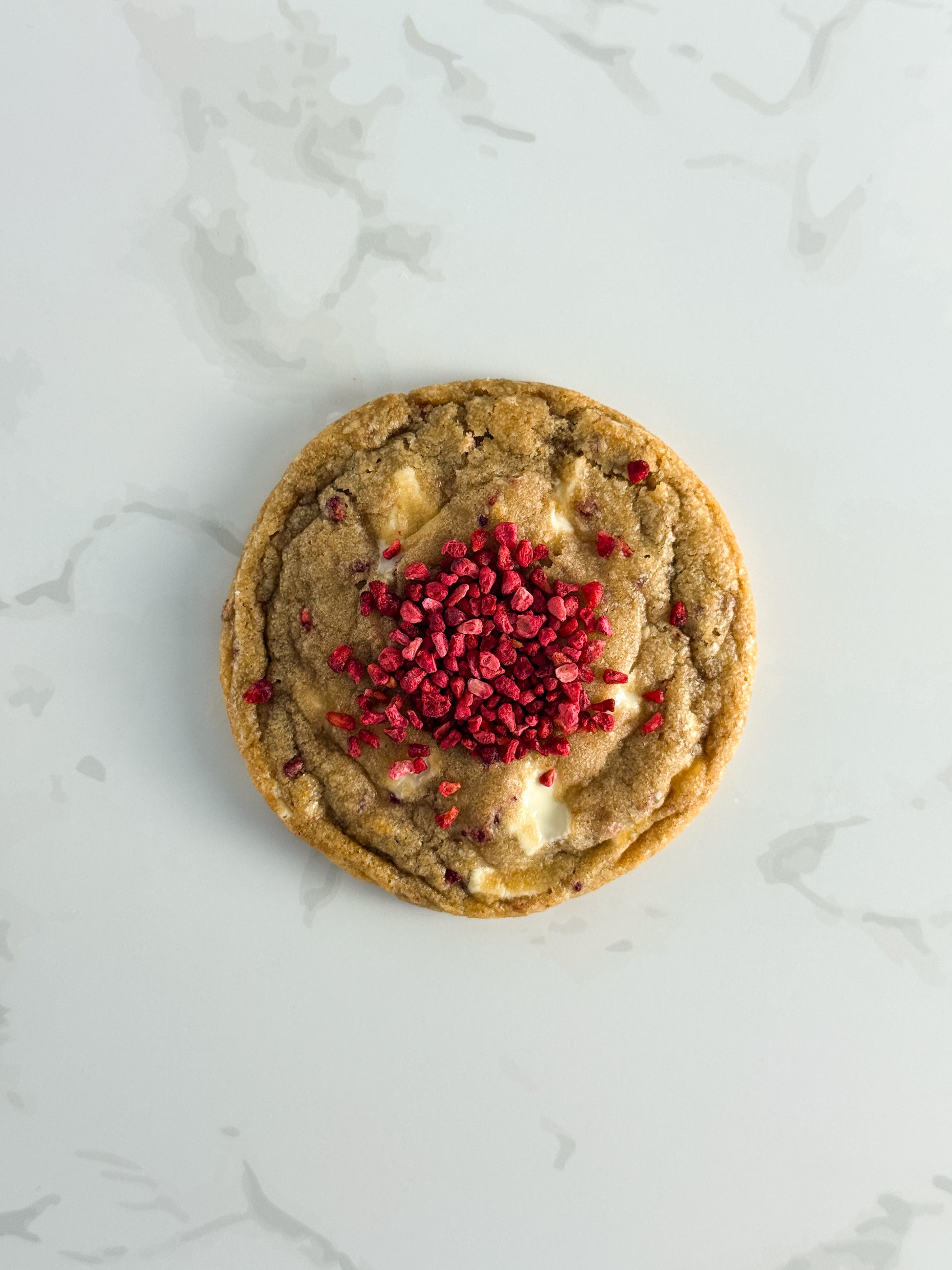 Half Three white chocolate and raspberry cookie topped with freeze-dried raspberries and white chocolate